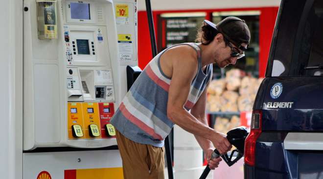 Man putting gas in vehicle