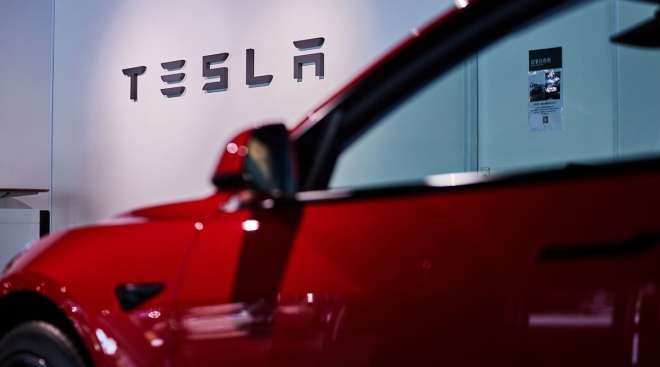 Tesla logo and vehicle at the company's store in Tokyo