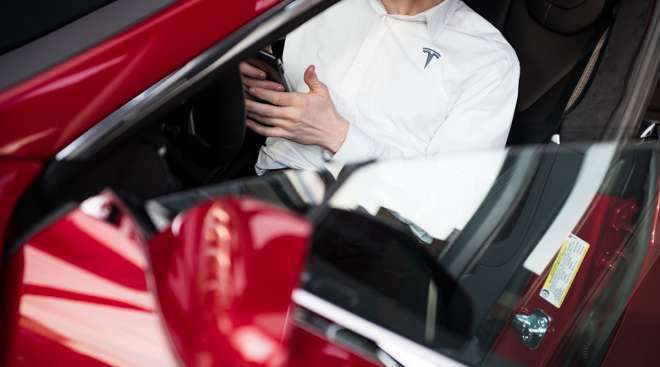 Employee in a Tesla